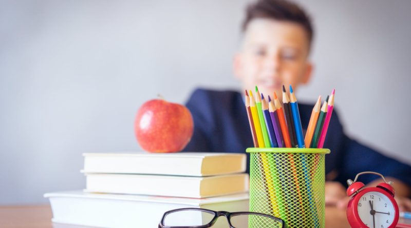 boy looking on a tidied desk