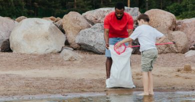 two men cleaning at the beach