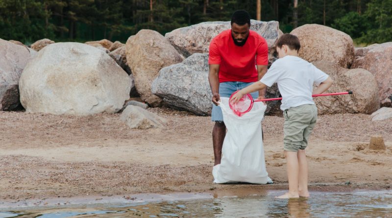 two men cleaning at the beach